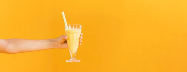 Person holding a glass of juice