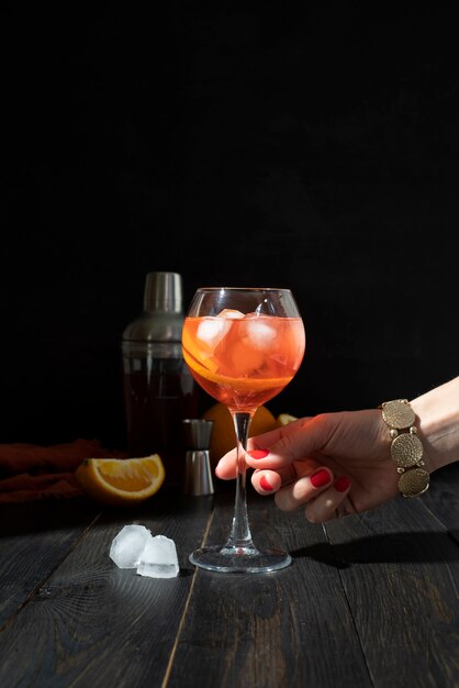 Person holding glass of refreshing cocktail drink