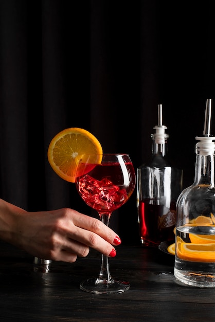 Person holding glass of refreshing cocktail drink