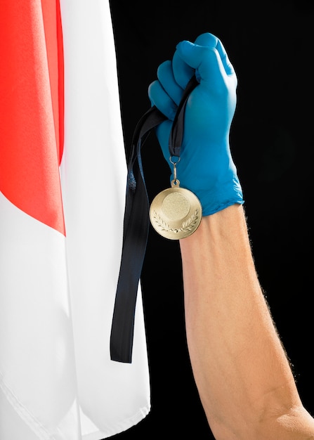 Person holding a golden medal