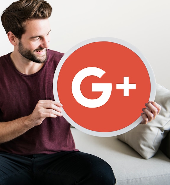 Free photo person holding a google plus icon