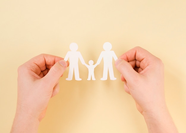 Free photo person holding in hands cute paper family