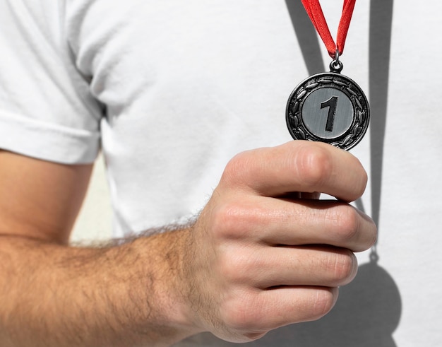 Person holding his number one medal
