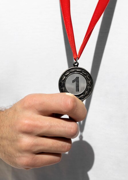 Person holding his number one medal