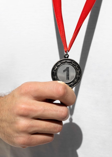 Person holding his number one medal