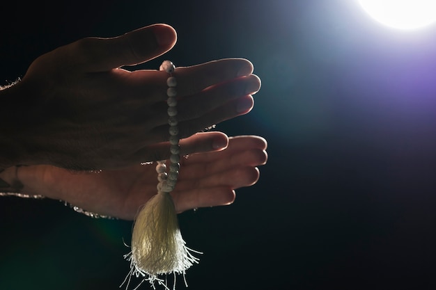 Person holding holy bracelet on full moon