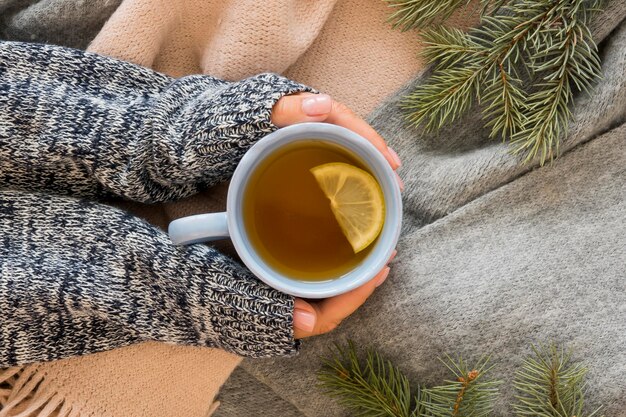 Free photo person holding hot tea with lemon