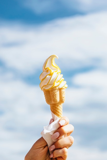 Person holding ice cream in the summer time