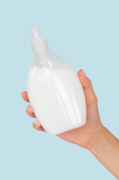 Person holding liquid soap bottle