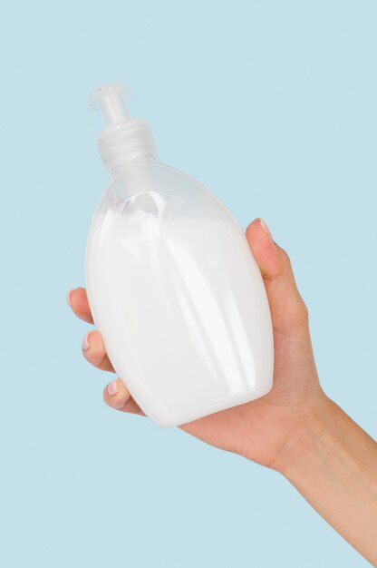 Person holding liquid soap bottle