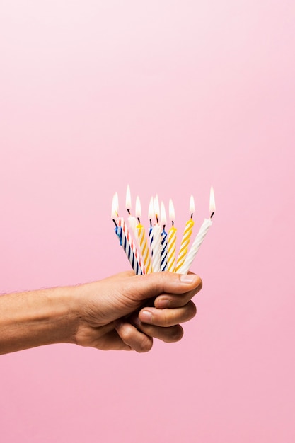 Person holding lit birthday candles