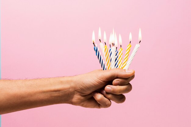 Person holding lit candles