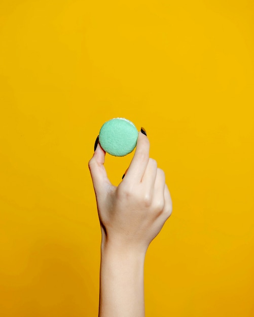 A person holding macaron