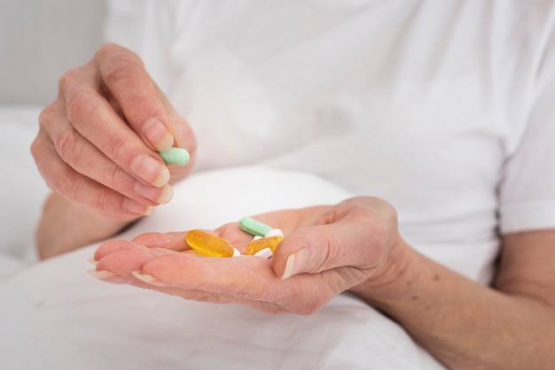 Free photo person holding many colorful pills