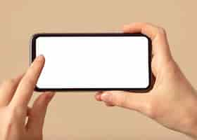 Free photo person holding a mobile phone with white screen