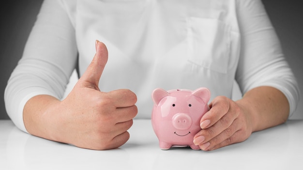 Person holding a piggy bank