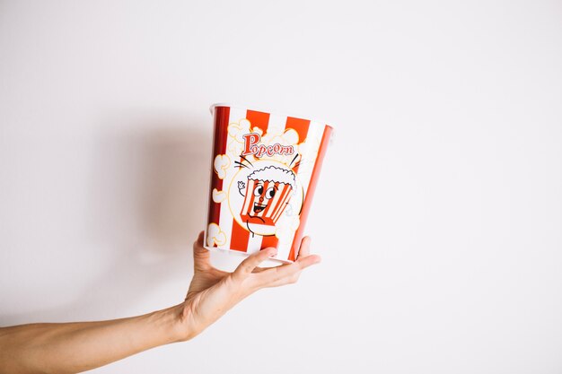 Person holding popcorn bucket