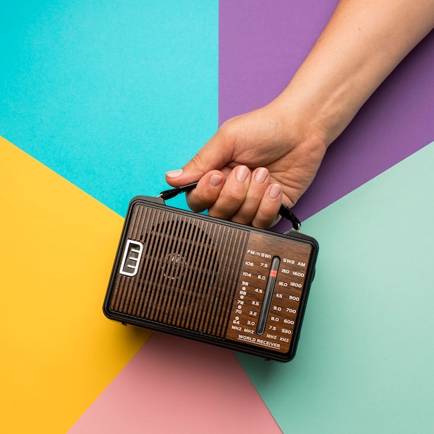 Free photo person holding retro broadcast radio receiver