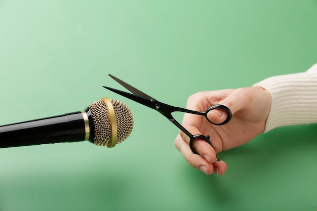 Person holding scissors close to microphone for asmr