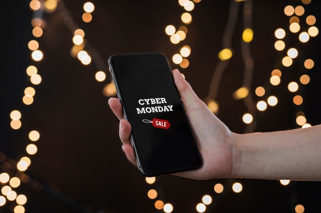 Person holding smartphone with Cyber Monday inscription 