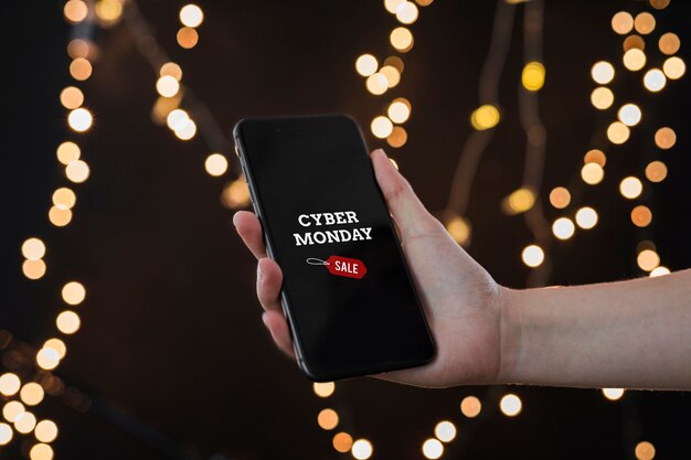 Person holding smartphone with Cyber Monday inscription 