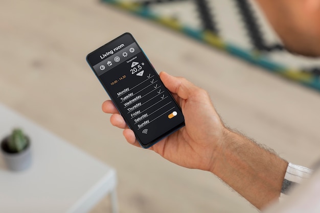 Person holding a smartphone with a home automation app