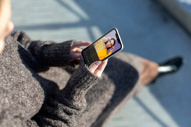 Person holding smartphone with social media app