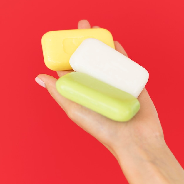 Free photo person holding soaps