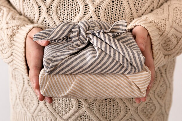 Person holding some wrapped christmas gifts