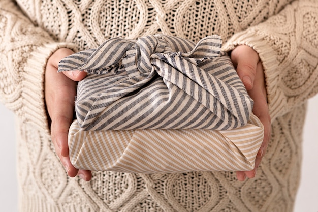 Person holding some wrapped christmas gifts