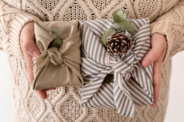 Person holding some wrapped christmas gifts