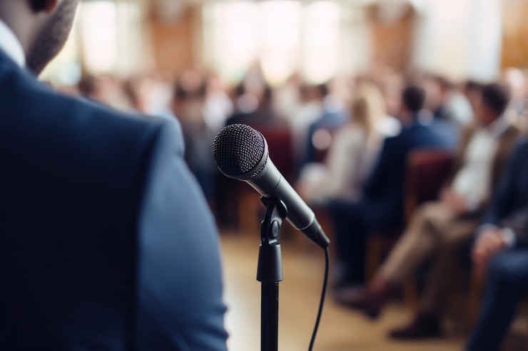 Free Photo person holding a speech at official event