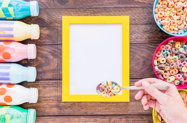 Free photo person holding spoon above frame