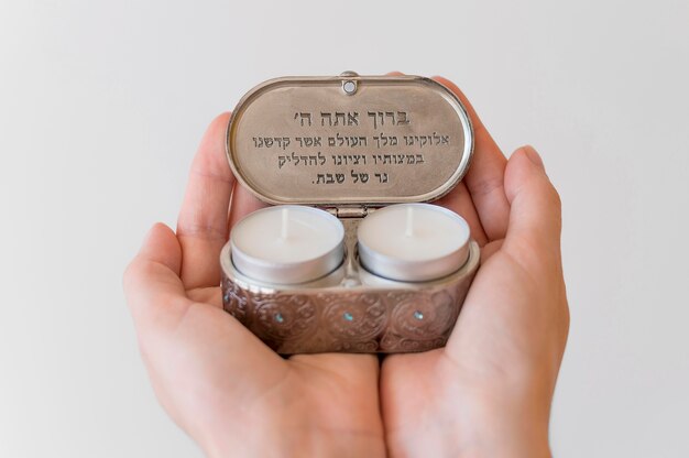 Person holding tea light candles for prayer