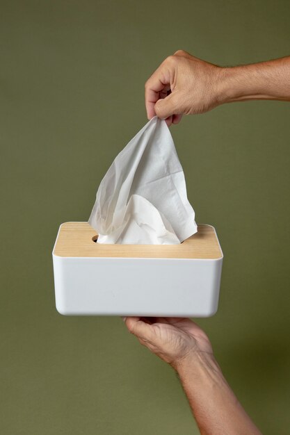 Person holding a white nasal handkerchief