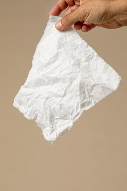 Person holding a white nasal handkerchief