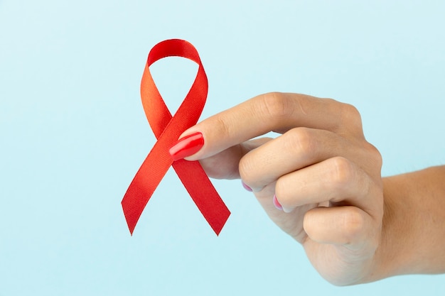 Person holding an world aids day ribbon symbol