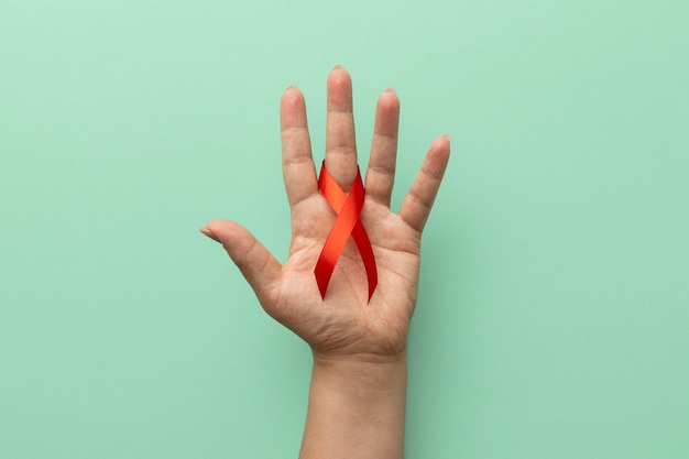 Person holding an world aids day ribbon