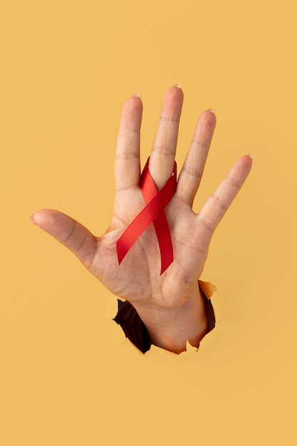 Person holding an world aids day ribbon