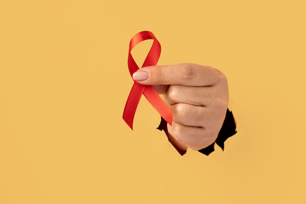 Persona che tiene in mano un nastro per la giornata mondiale dell'aids