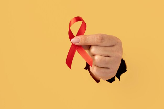 Person holding an world aids day ribbon