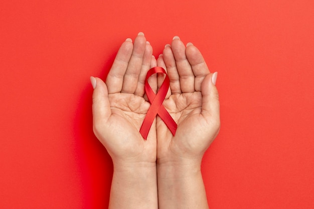 Person holding an world aids day ribbon