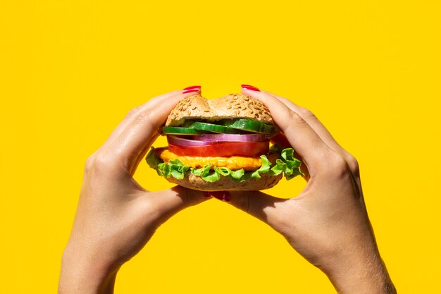 Person holding a yummy veggie burger