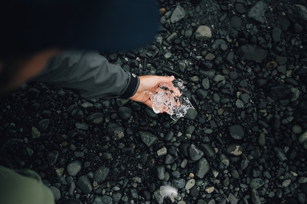Person holds piece of glacier ice in iceland