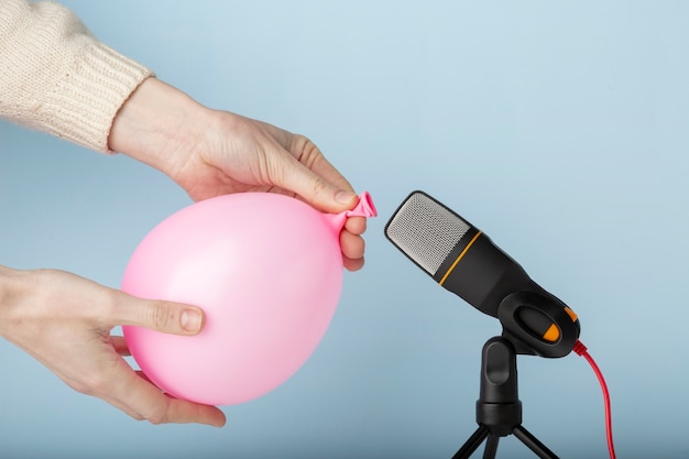 Person letting the air out of a balloon close to microphone for asmr