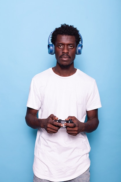 Person looking at camera while using controller and headphones