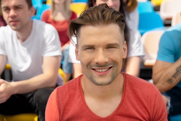 Person looking at a football game in a sunny day