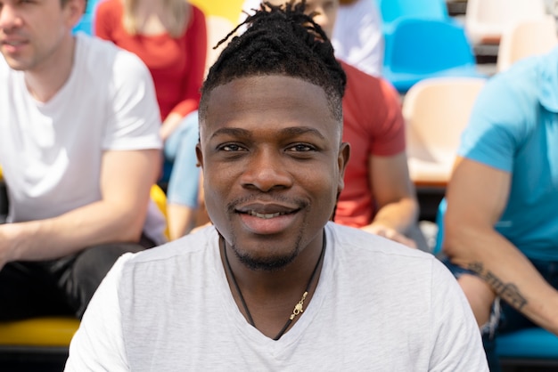 Free photo person looking at a football game in a sunny day