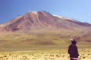 Free photo person looking at a huge mountain