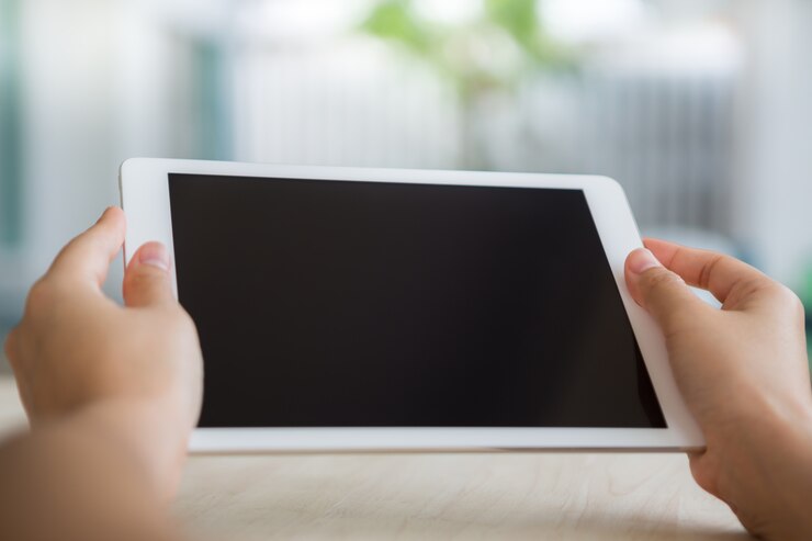 Free Photo person looking at a tablet